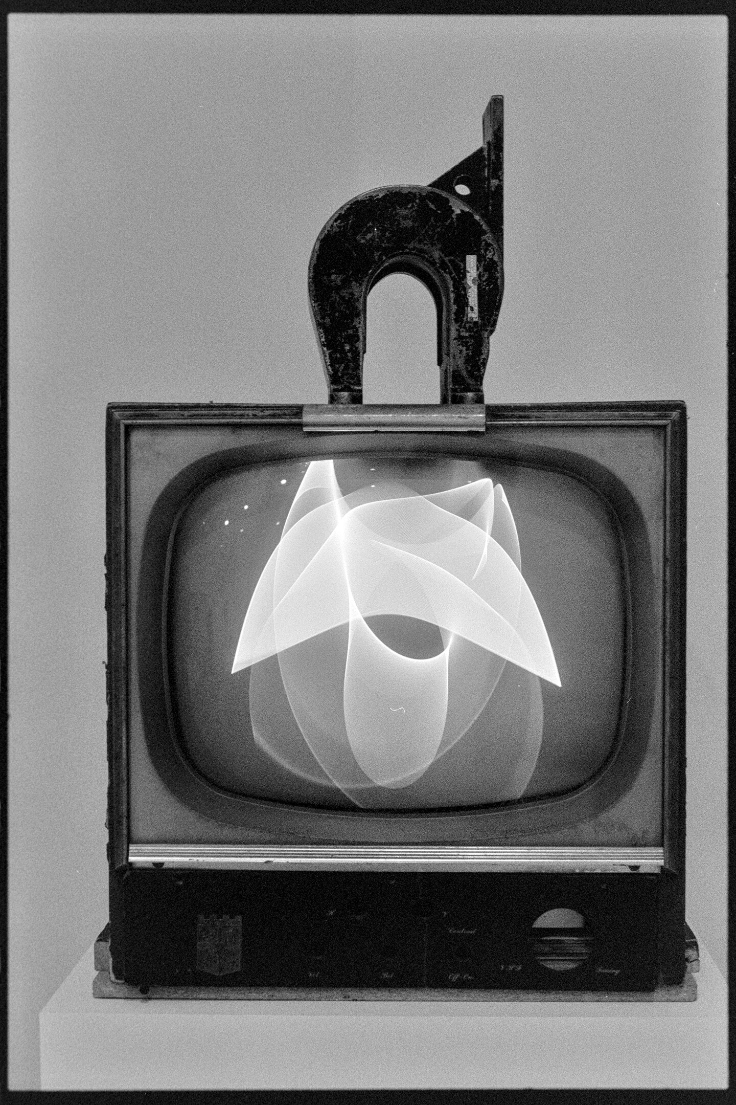 A horseshoe magnet on top of an old black and white TV, a piece called Magnet TV by Nam June Paik on display at the Whitney