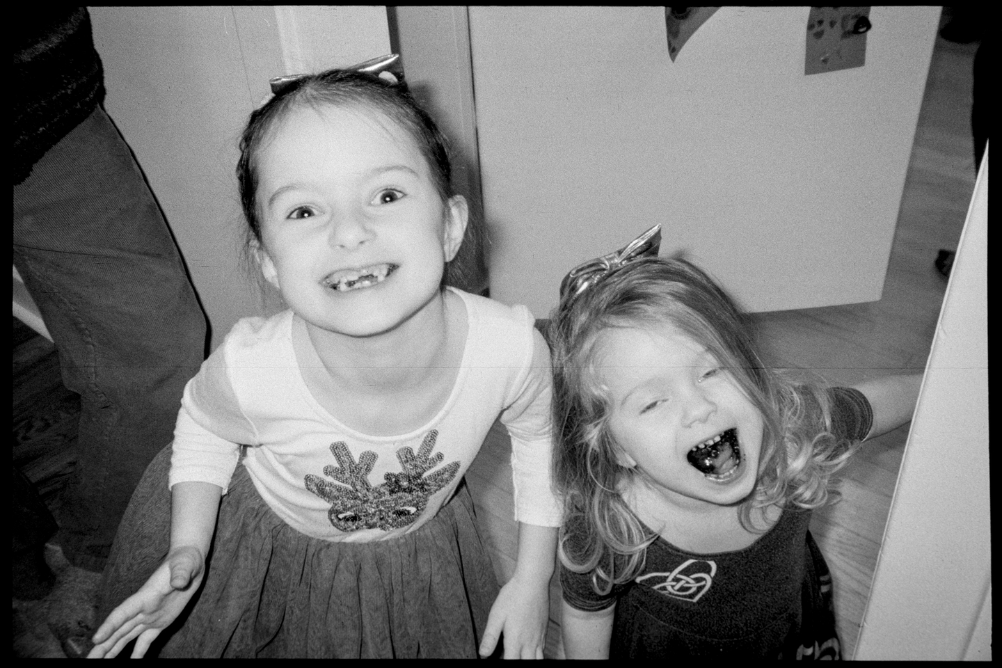 Young sisters Lena and Isla make faces at the camera during the solstice party