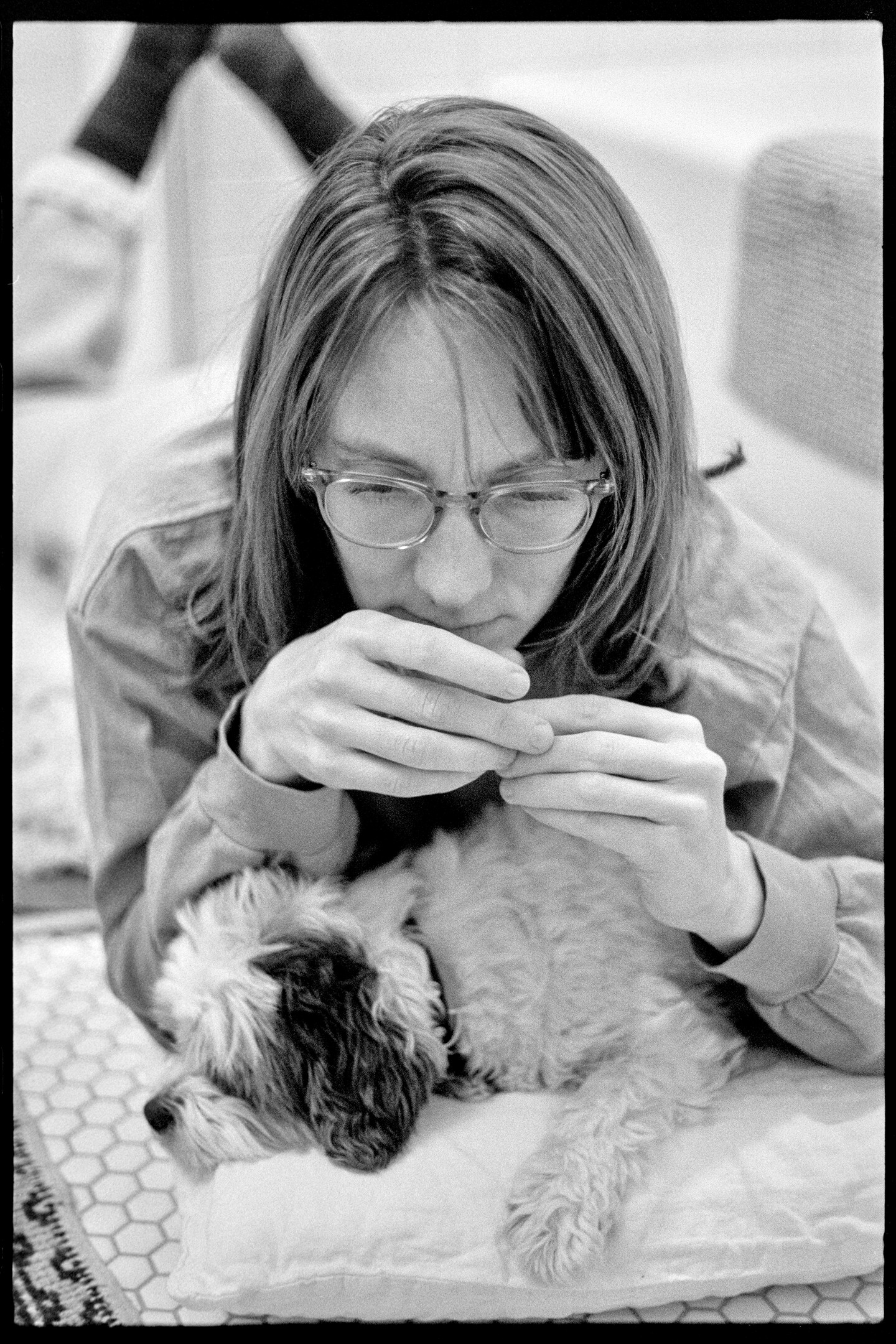 Kallie cuddling with Annie the dog in the bathroom