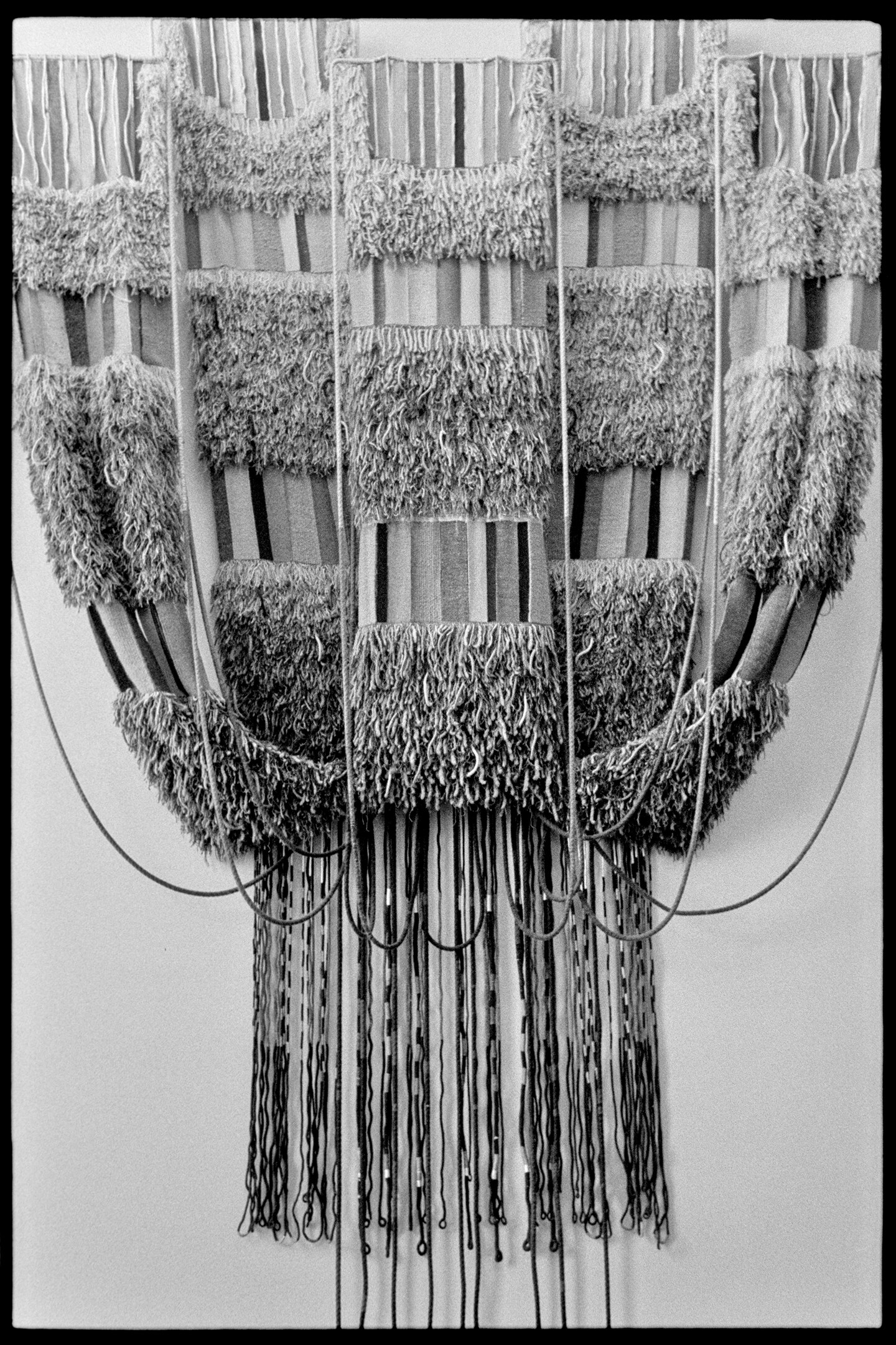 Twenty foot tall macramé piece hanging on the wall of the Carleton College library