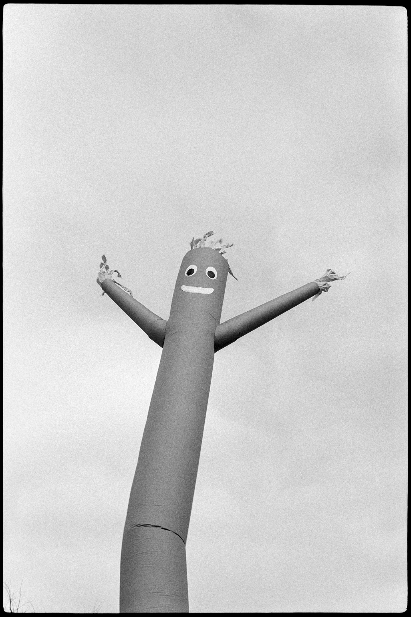 Inflatable tube man set against the sky