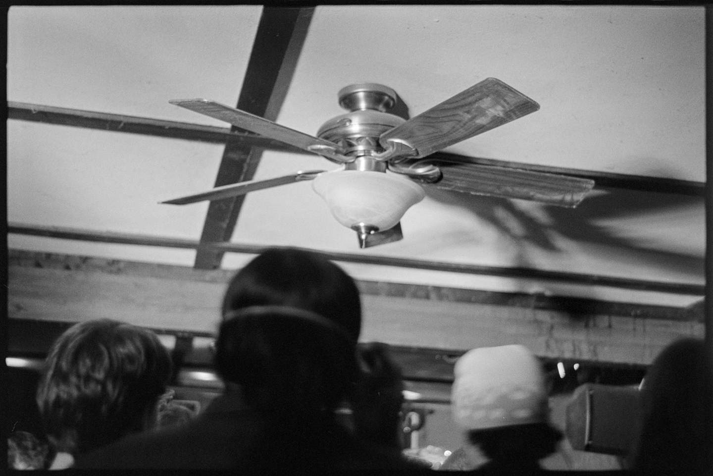 A ceiling fan above a group of young people at a concert venue in Northfield, Minnesota