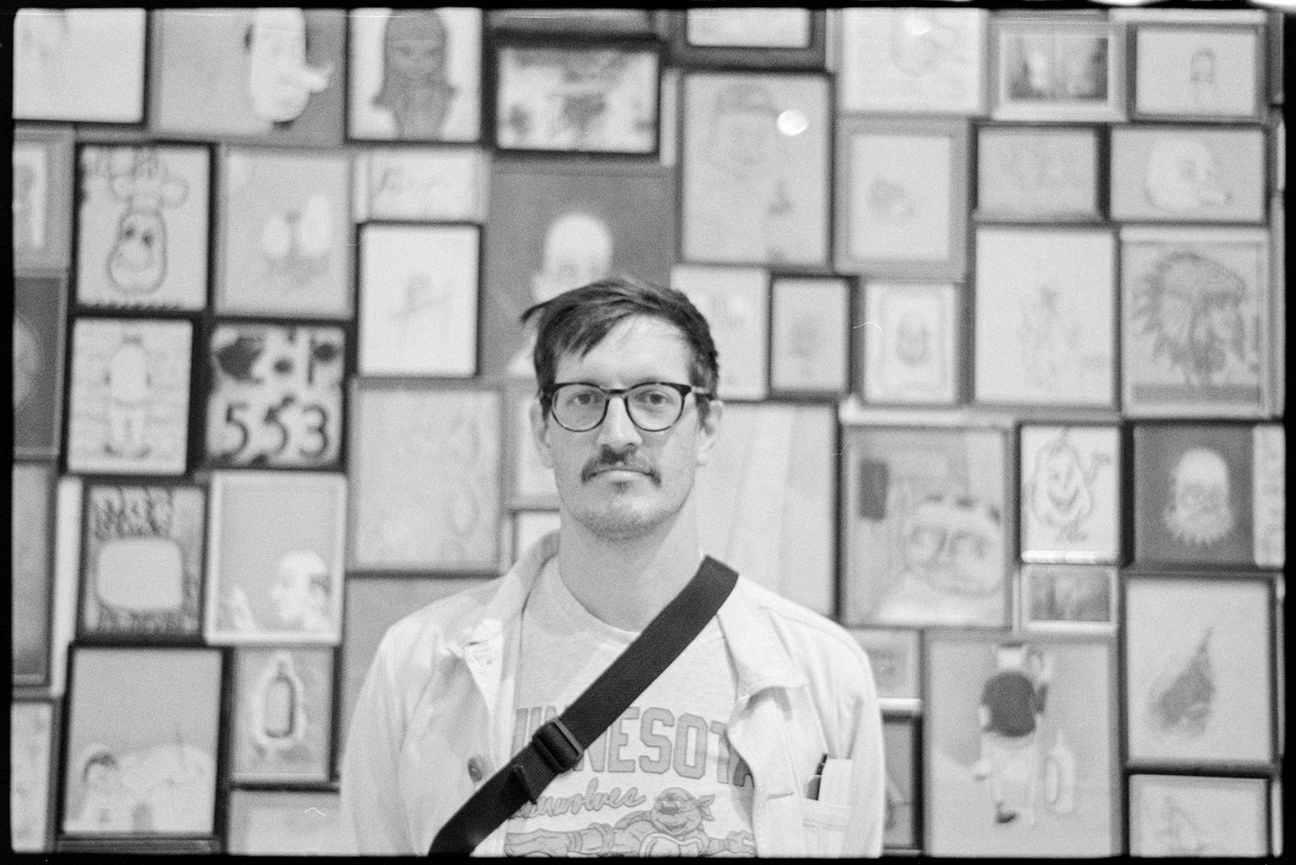 Jason standing in front of art by Jerry McGee at the San Francisco Museum of Modern Art