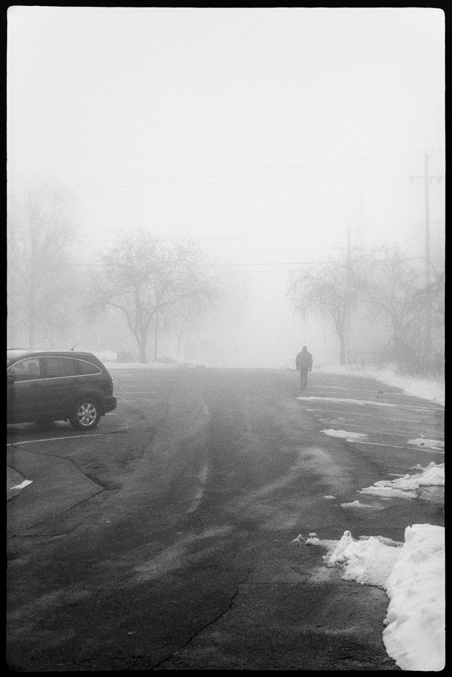A man walking up a hill on a foggy day