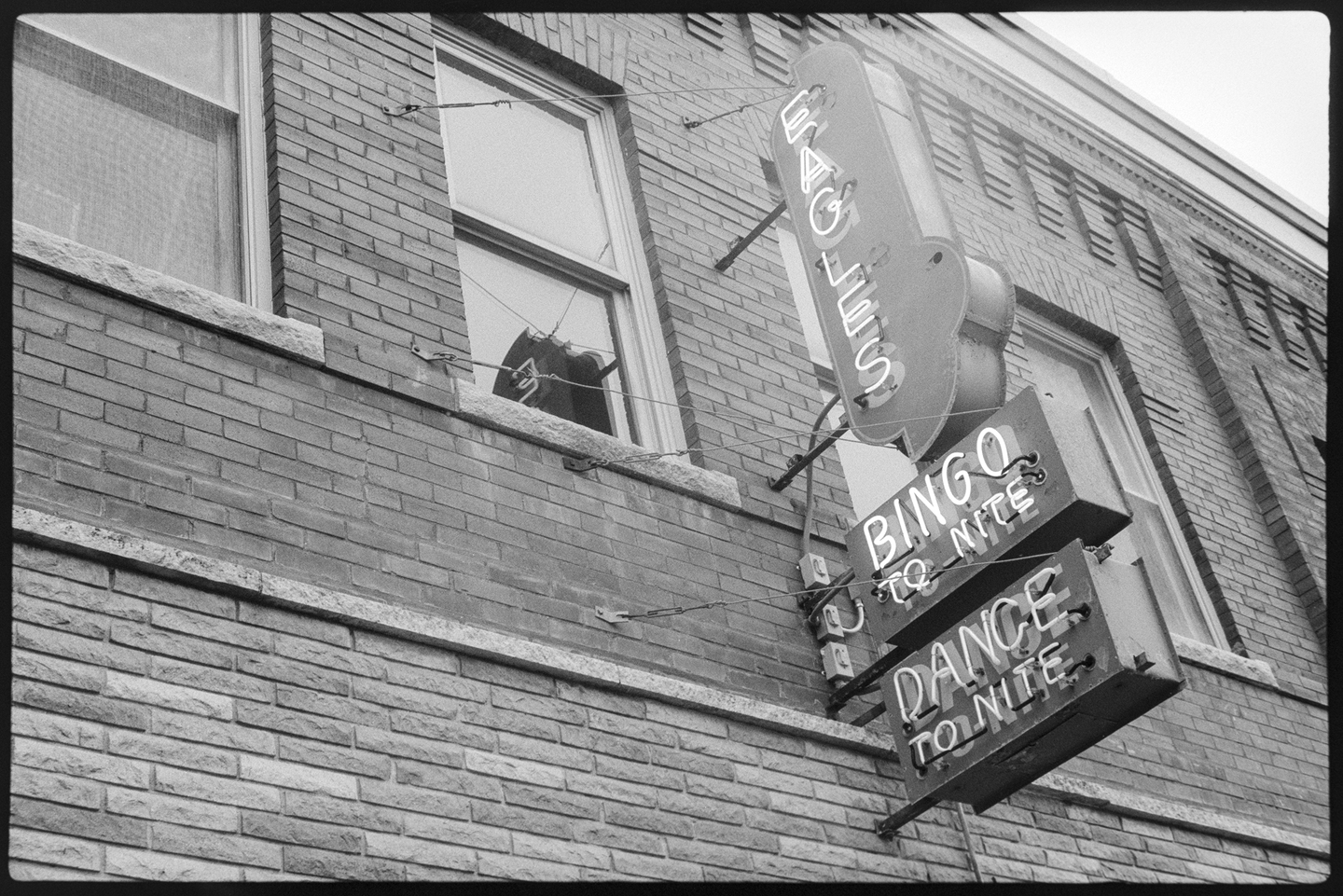Neon sign of the Eagles Club on the front of their building