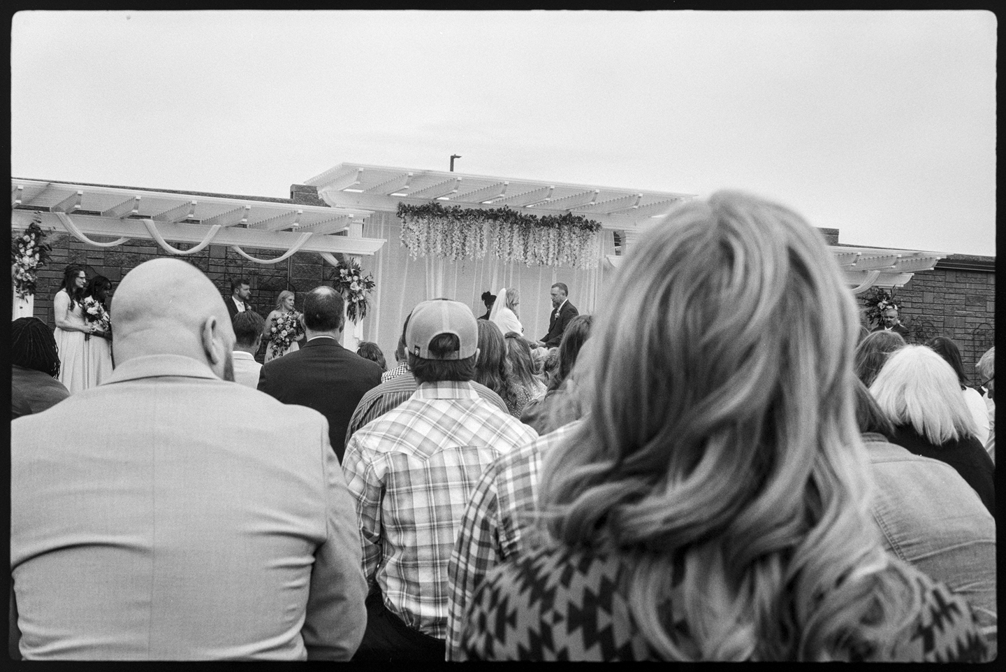 Two people getting married in front of a crowd
