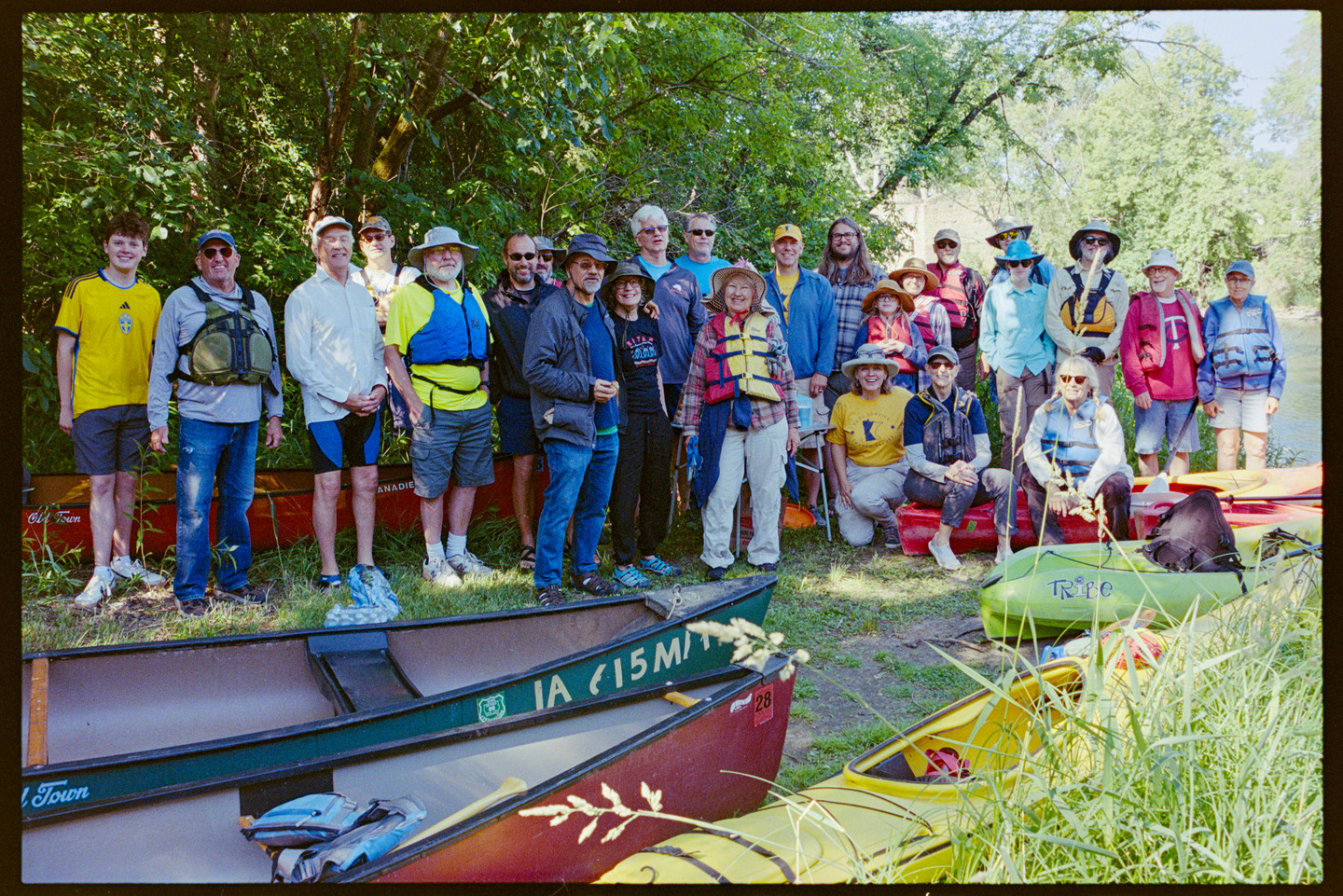 Group photo of a bunch of people about to go on a kayak excursion in the Cannon River