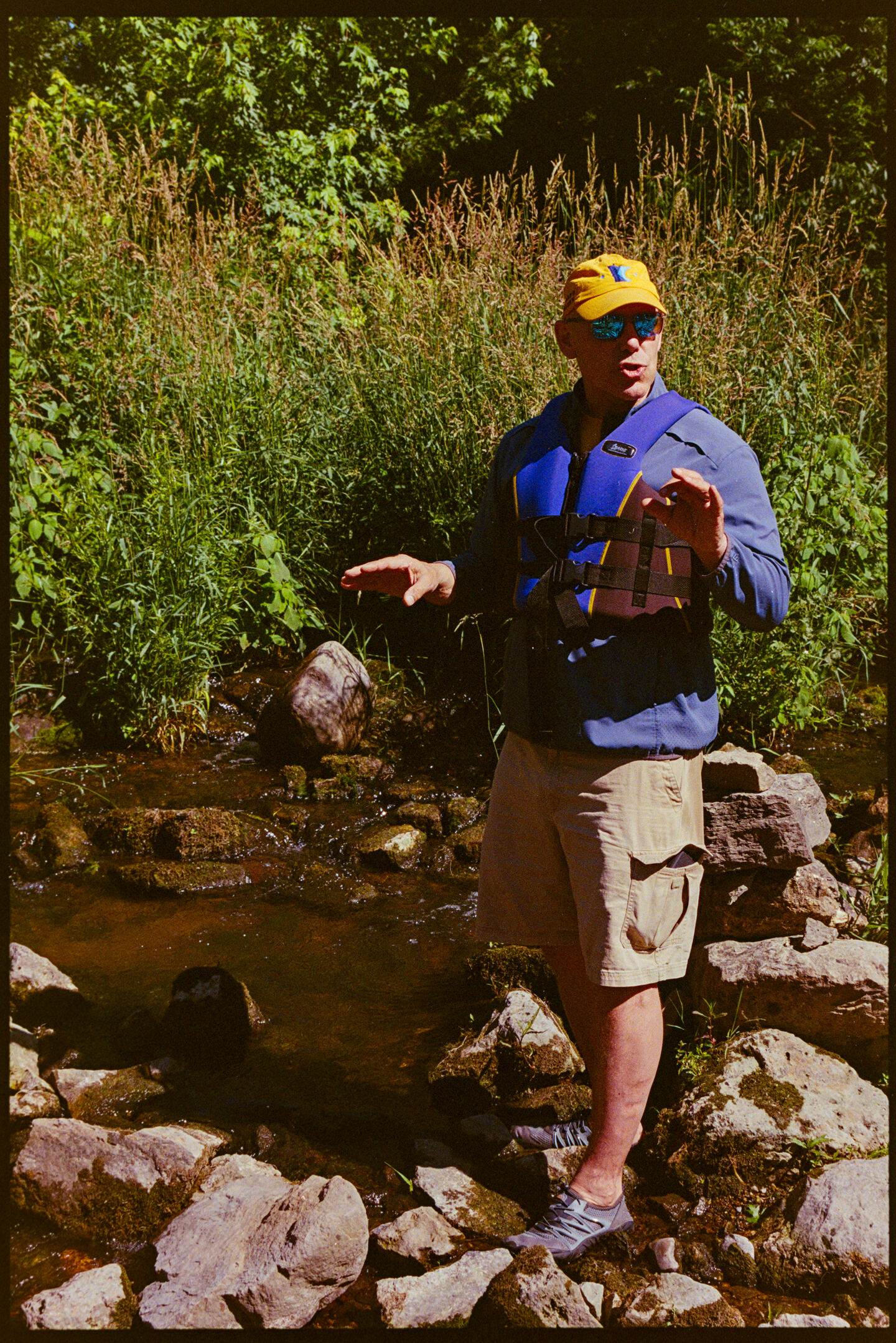 A man explains to a group the importance of water quality in rural Minnesota and the water habitats that are impacted